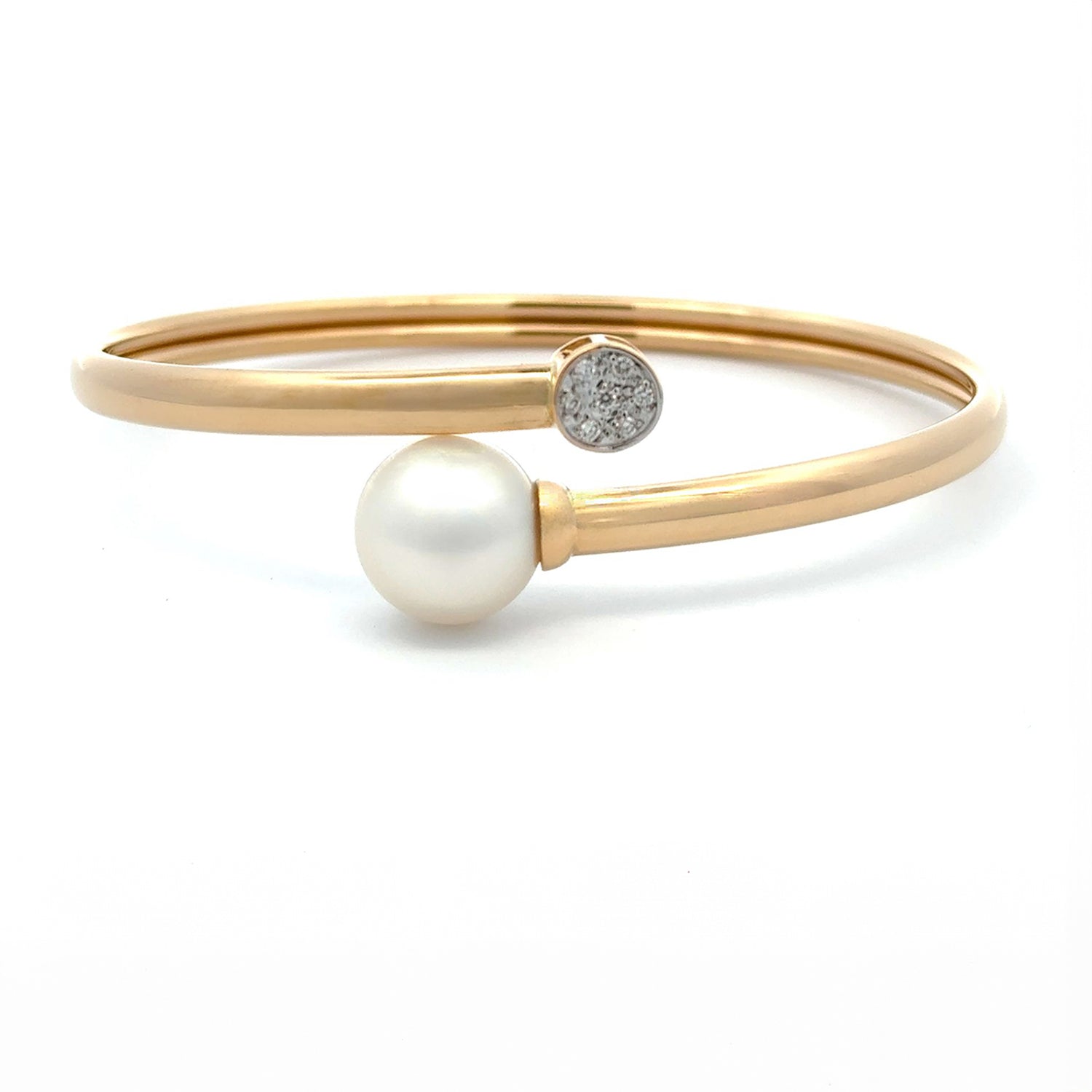 A yellow gold Australian South Sea pearl and diamond bangle displayed against a white background.