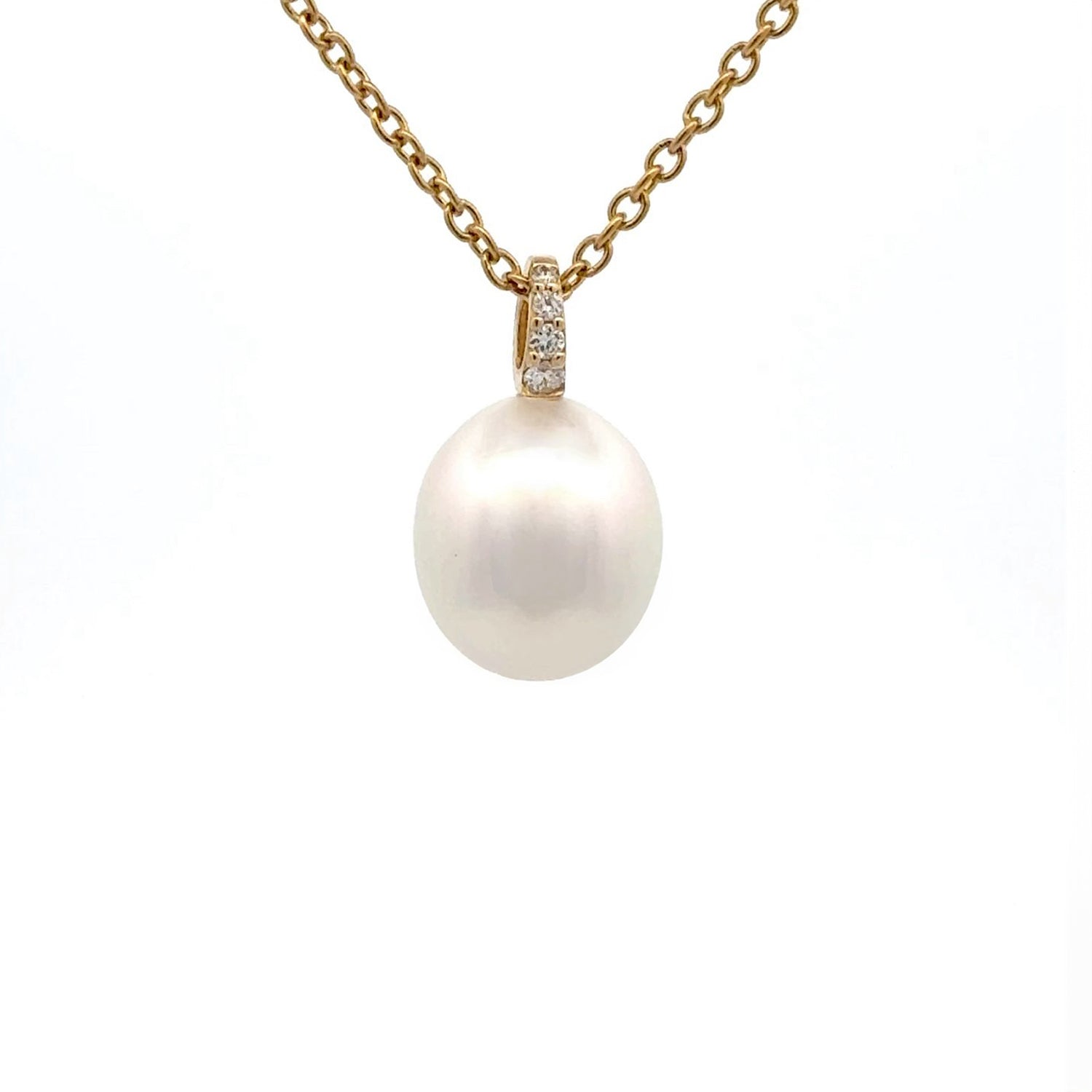 A yellow gold Australian South Sea pearl and diamond pendant hangs on a yellow gold chain against a white background.